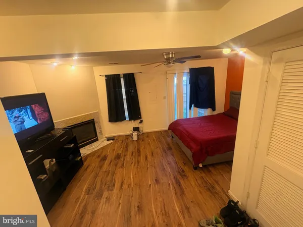 a spacious bedroom with a bed and a mirror