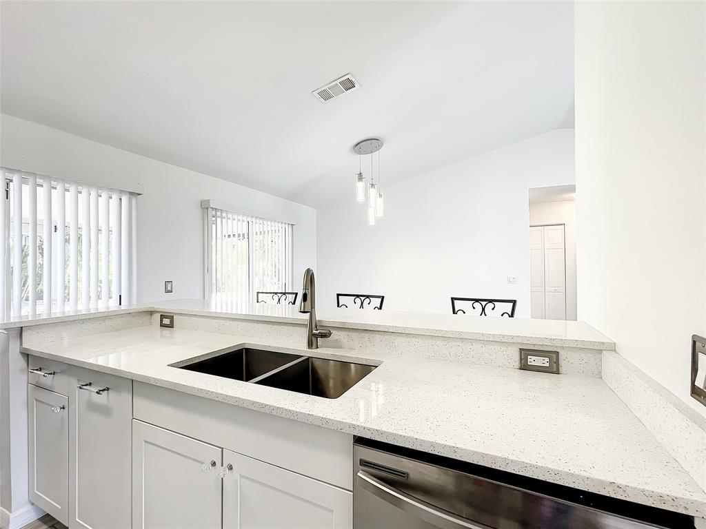 2887 Southwest Ann Arbor Road Port St. Lucie, FL 34953 - Photo 11 of 31 a kitchen with a sink and white cabinets
