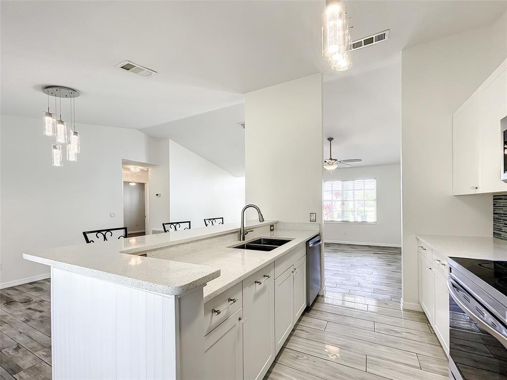 2887 Southwest Ann Arbor Road Port St. Lucie, FL 34953 - Photo 12 of 31 a kitchen with granite countertop a sink and cabinets