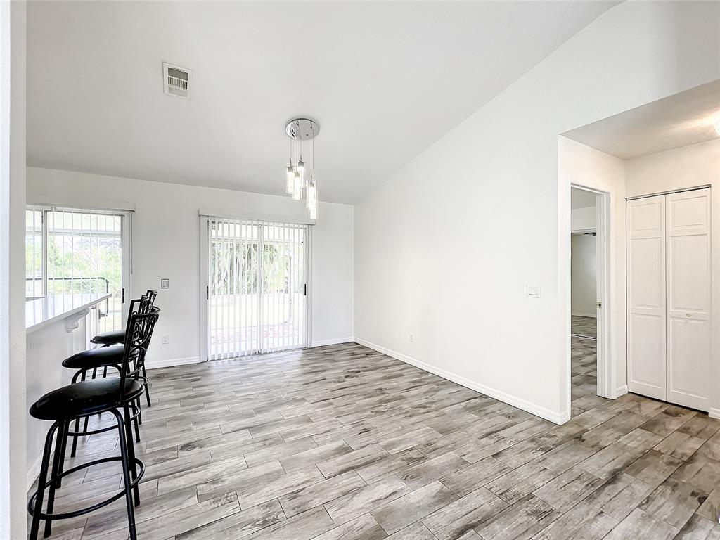 2887 Southwest Ann Arbor Road Port St. Lucie, FL 34953 - Photo 13 of 31 a view of an empty room with window and wooden floor