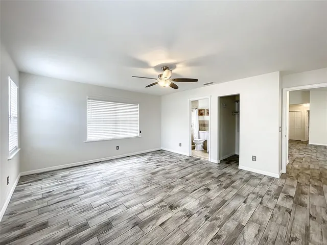 a view of a livingroom with a ceiling fan and window