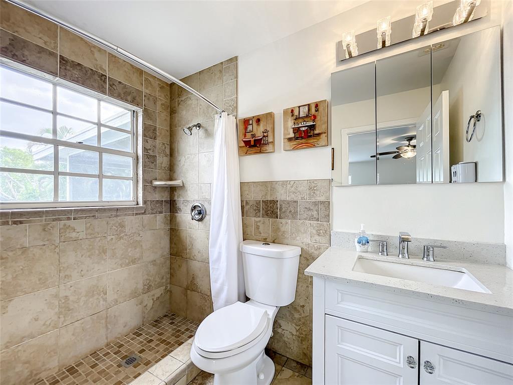2887 Southwest Ann Arbor Road Port St. Lucie, FL 34953 - Photo 19 of 31 a bathroom with a sink a toilet and shower
