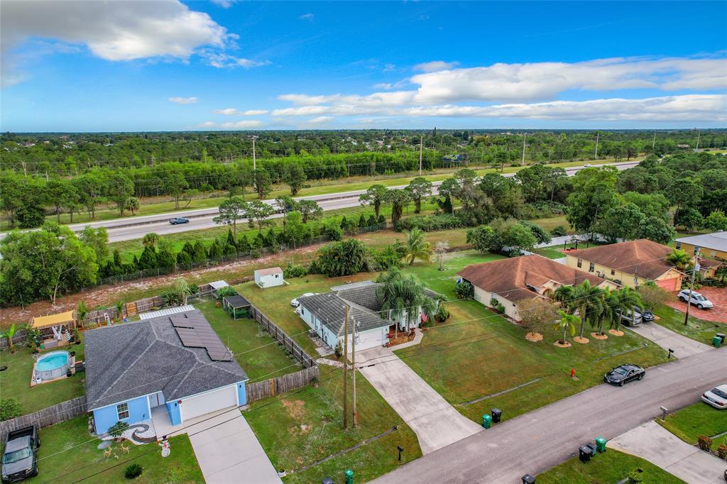 2887 Southwest Ann Arbor Road Port St. Lucie, FL 34953 - Photo 2 of 31 an aerial view of a house with a garden