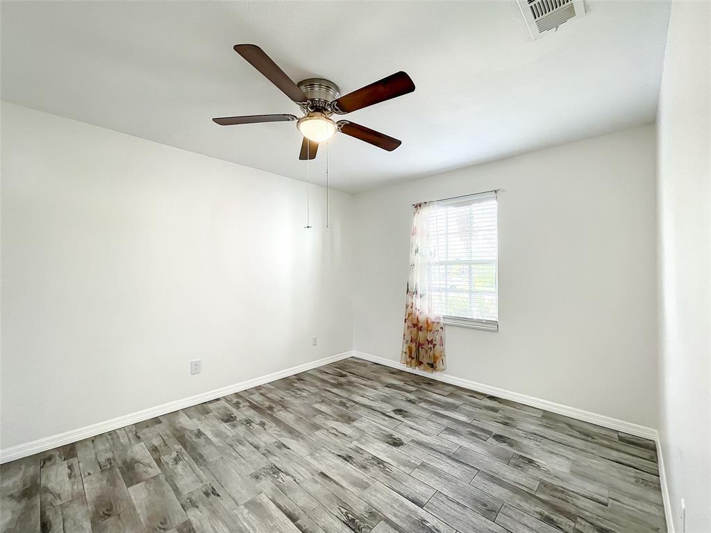 2887 Southwest Ann Arbor Road Port St. Lucie, FL 34953 - Photo 23 of 31 a view of empty room with wooden floor and fan