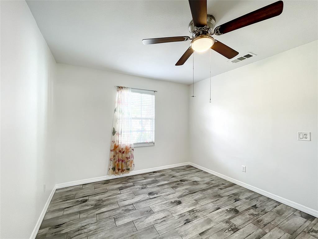 2887 Southwest Ann Arbor Road Port St. Lucie, FL 34953 - Photo 24 of 31 wooden floor in an empty room with a window