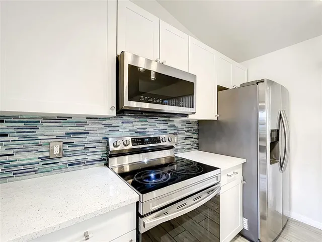 a kitchen with a sink and white cabinets