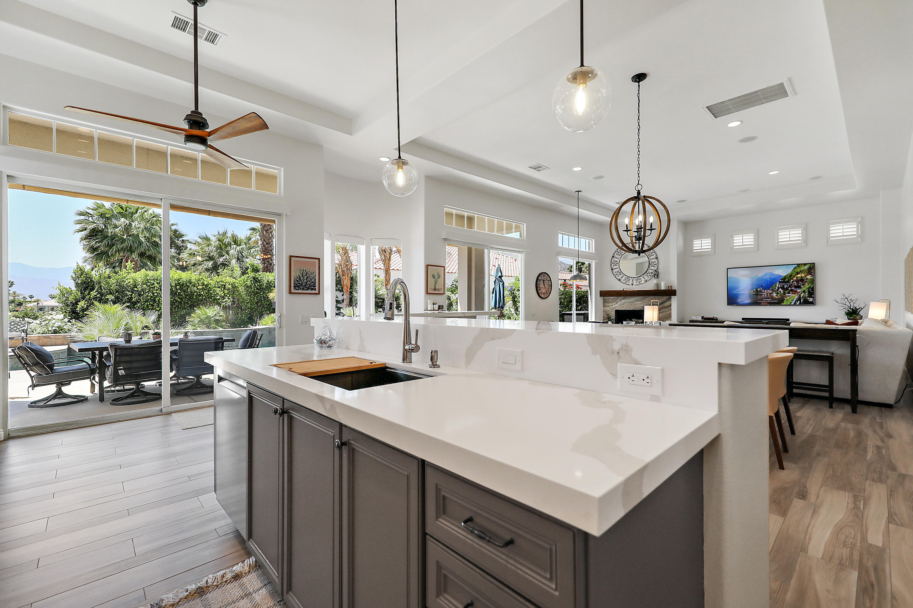80345 Camarillo Way La Quinta, CA 92253 - Photo 13 of 40 a kitchen with a stove a counter space a sink and a large window