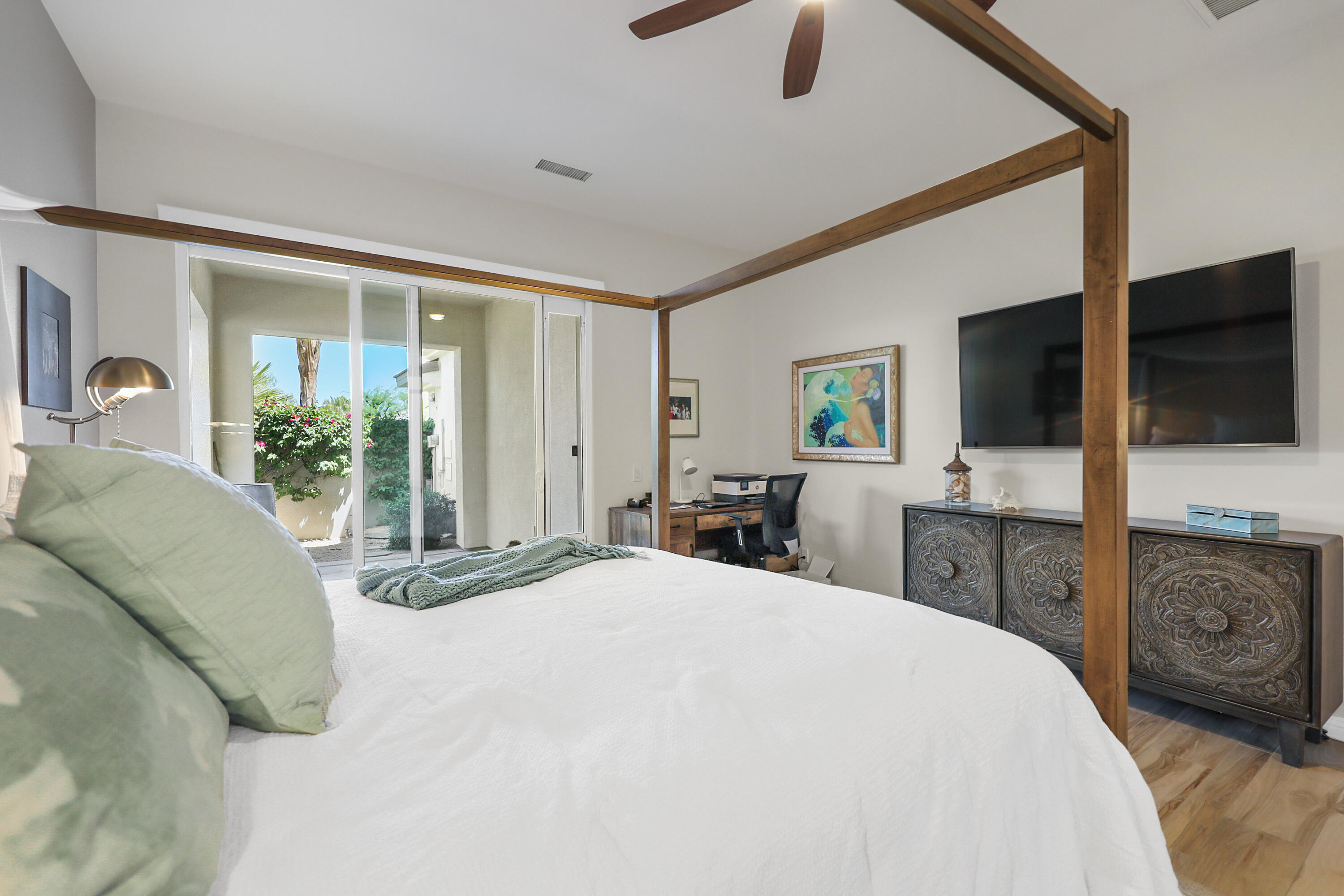 80345 Camarillo Way La Quinta, CA 92253 - Photo 17 of 40 a bedroom with a large bed and flat tv screen on dresser