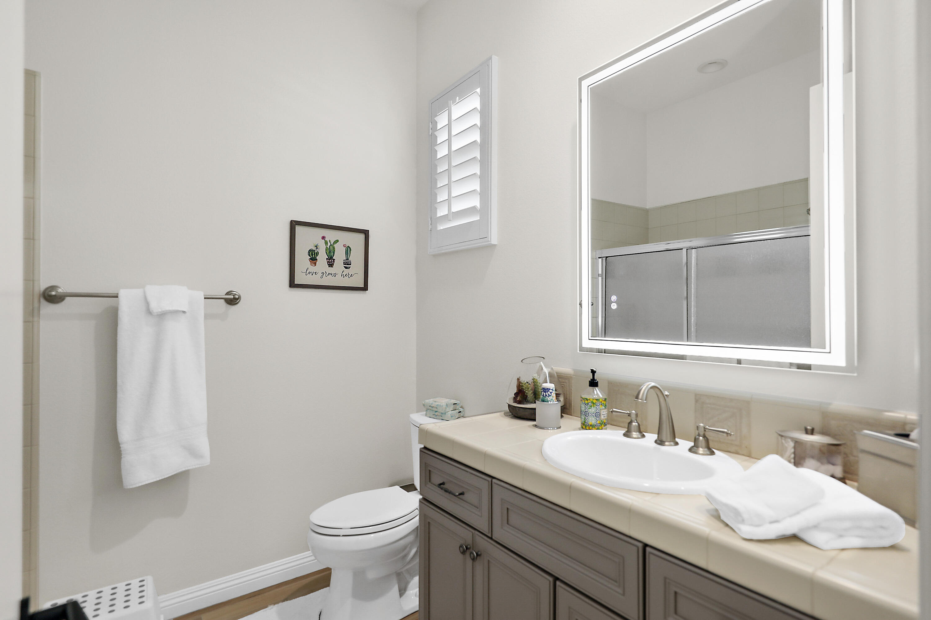 80345 Camarillo Way La Quinta, CA 92253 - Photo 24 of 40 a bathroom with a granite countertop sink toilet and mirror