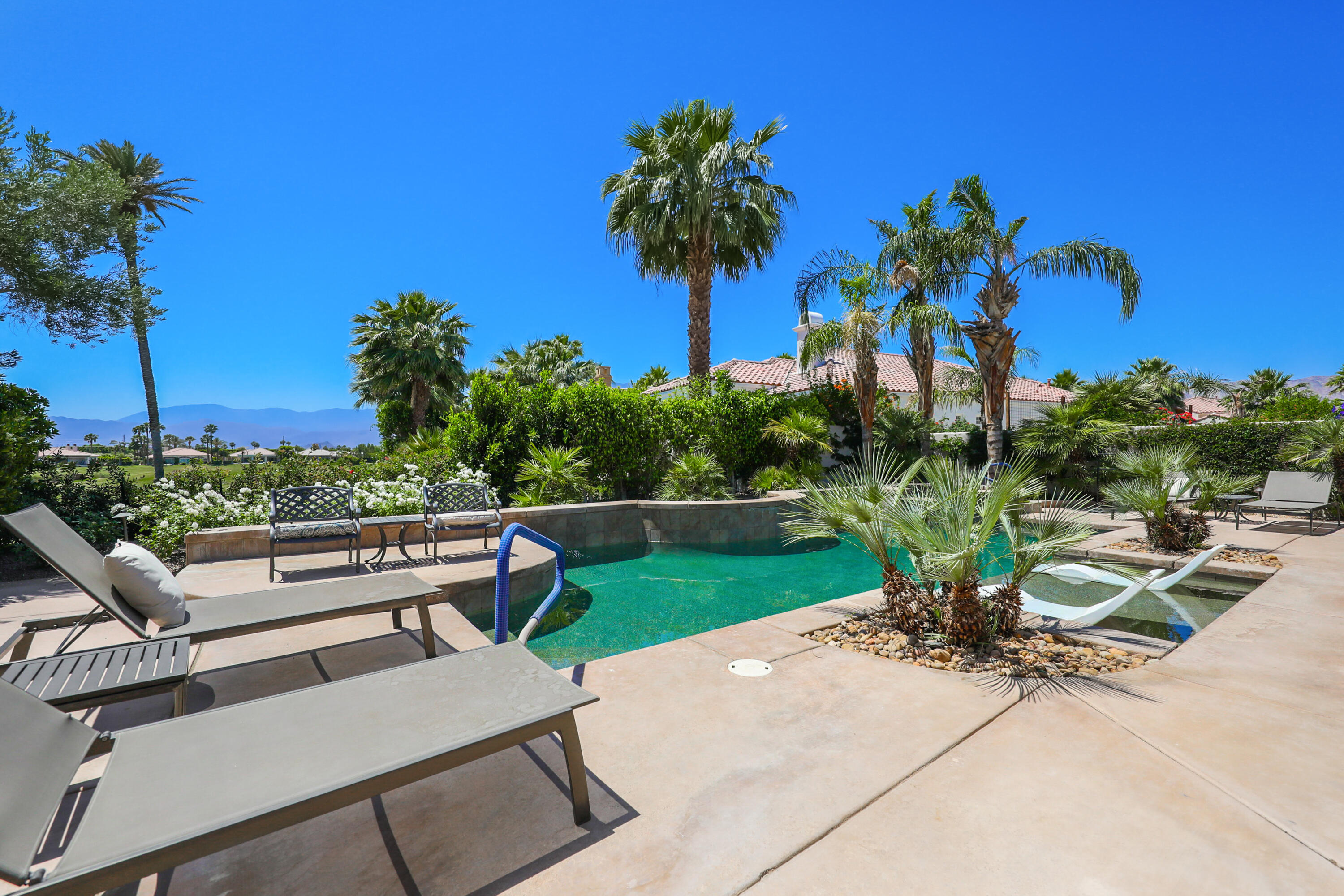 80345 Camarillo Way La Quinta, CA 92253 - Photo 28 of 40 a view of a patio with a table and chairs under an umbrella