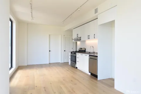 a kitchen with a refrigerator and a stove top oven