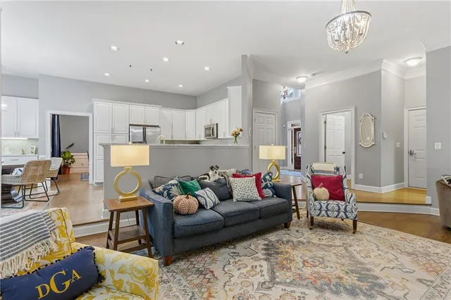 a living room with furniture and a chandelier