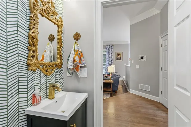 a bathroom with a sink and mirror with bathtub