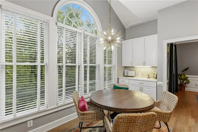 a dining room with furniture and window