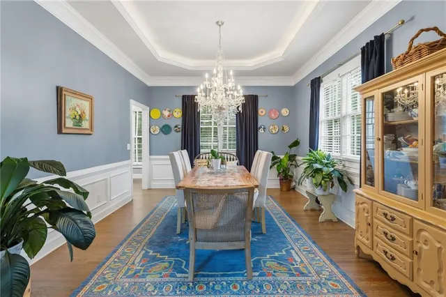 a living room with furniture a chandelier and a rug