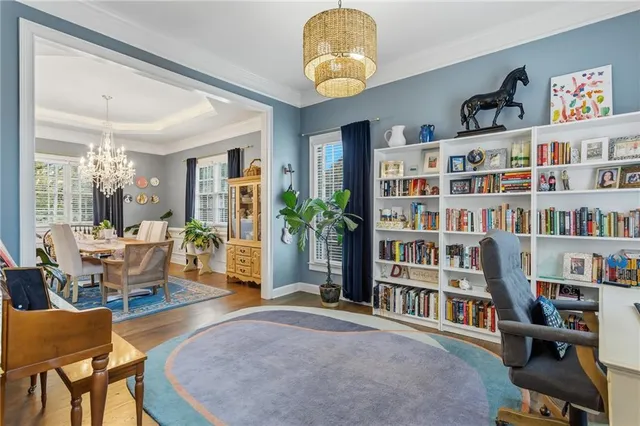 a view of a livingroom with furniture and bookshelf