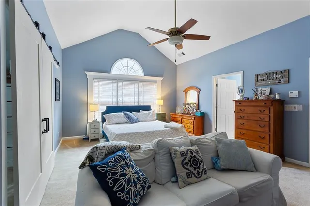 a bedroom with furniture and a large window