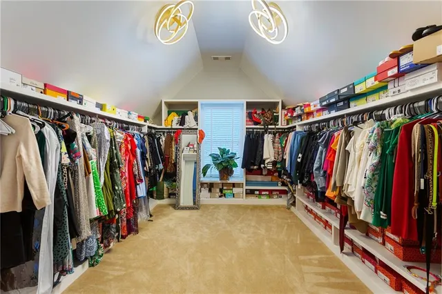 a view of walk in closet with clothes