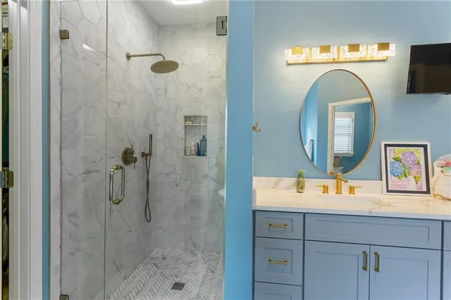 a bathroom with a sink a mirror and a shower