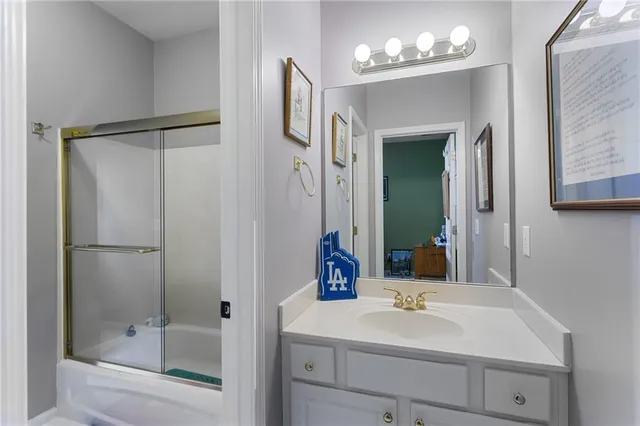 a bathroom with a sink a mirror and a shower