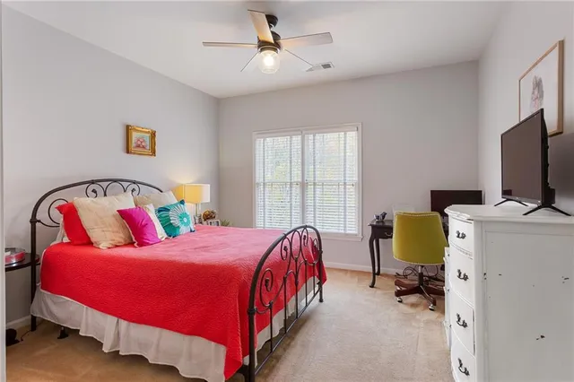 a bedroom with a bed chair and a window