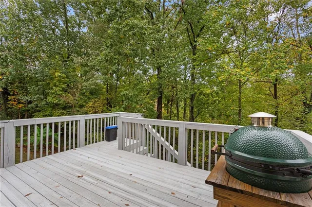 a balcony with wooden floor and fence
