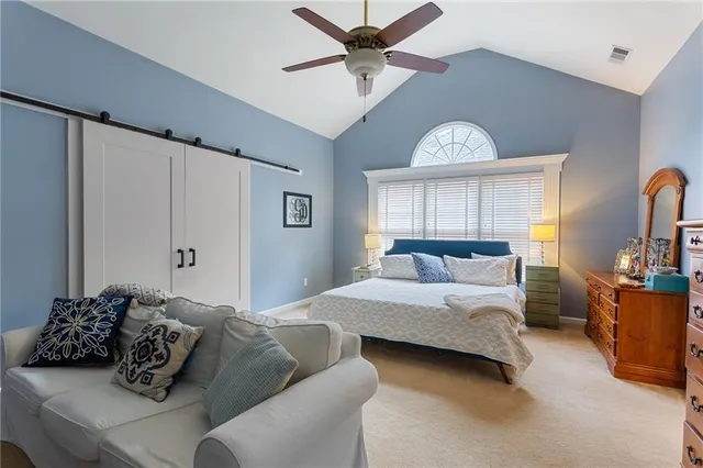 a bedroom with a bed window and couch