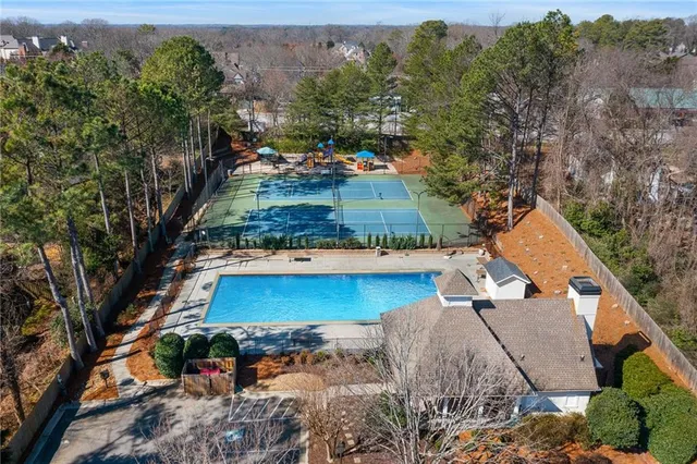 an aerial view of a house with a yard basket ball court and outdoor seating