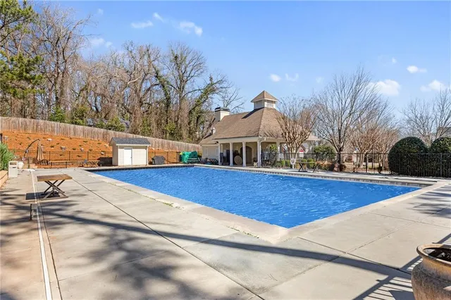 a view of a house with pool and yard