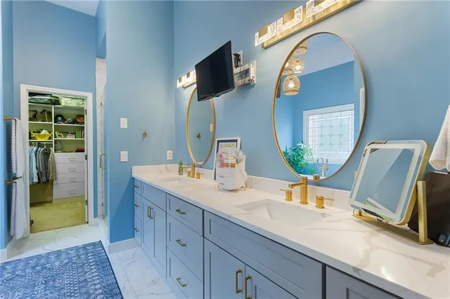 a bathroom with a granite countertop sink mirror and vanity