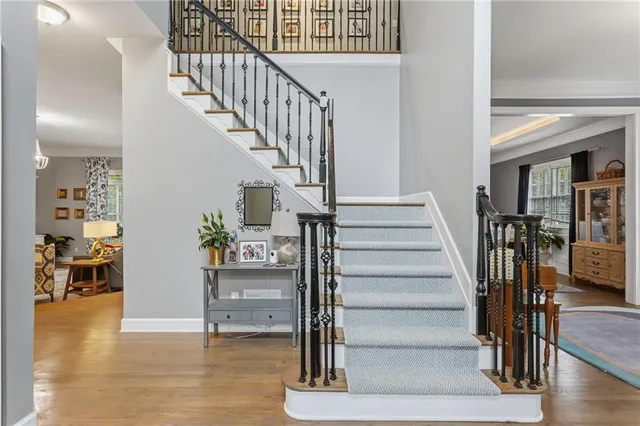 a view of entryway and hall with wooden floor