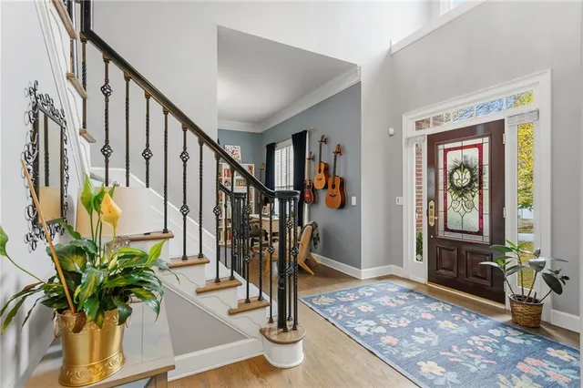 a view of an entryway with wooden floor and a livingroom