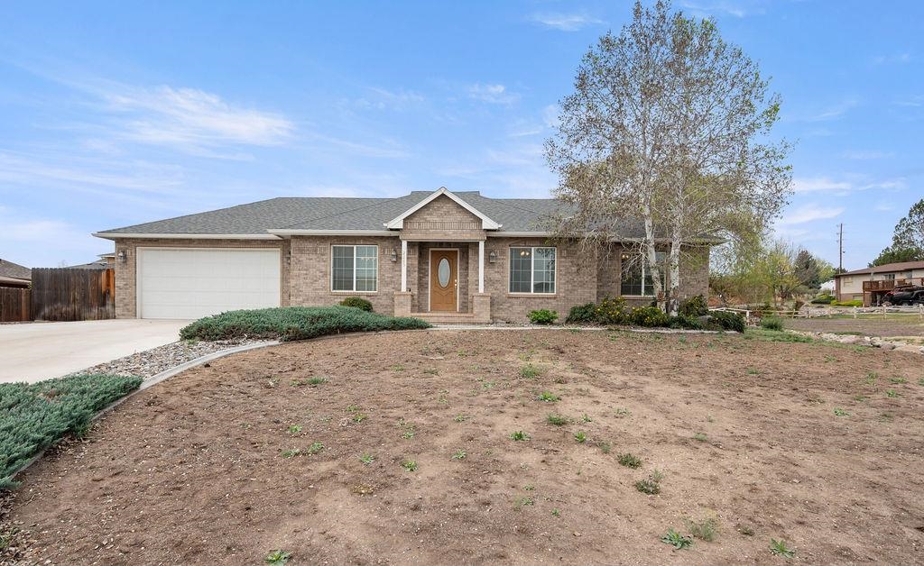 2285 Vista Rio Court Grand Junction, CO 81507 - Photo 1 of 34 a front view of a house with a yard and garage
