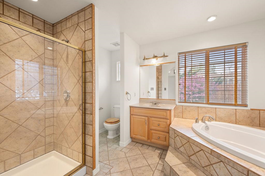 2285 Vista Rio Court Grand Junction, CO 81507 - Photo 11 of 34 a spacious bathroom with a granite countertop sink a toilet and shower