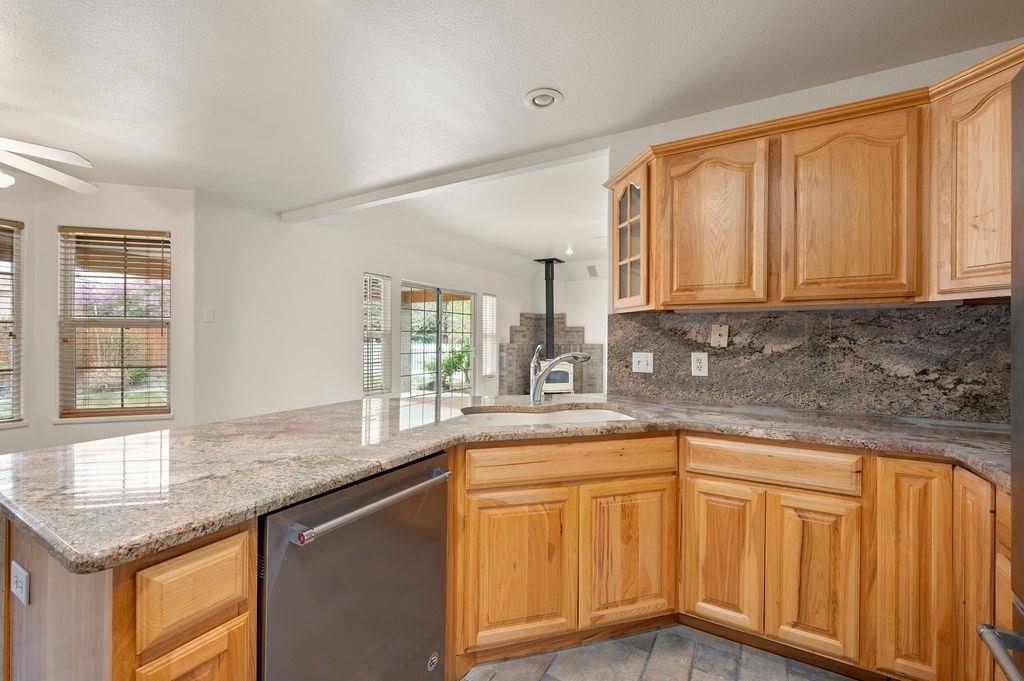2285 Vista Rio Court Grand Junction, CO 81507 - Photo 23 of 34 a kitchen with granite countertop cabinets sink and window