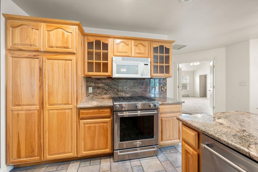 2285 Vista Rio Court Grand Junction, CO 81507 - Photo 24 of 34 a kitchen with stainless steel appliances granite countertop cabinets and wooden floor