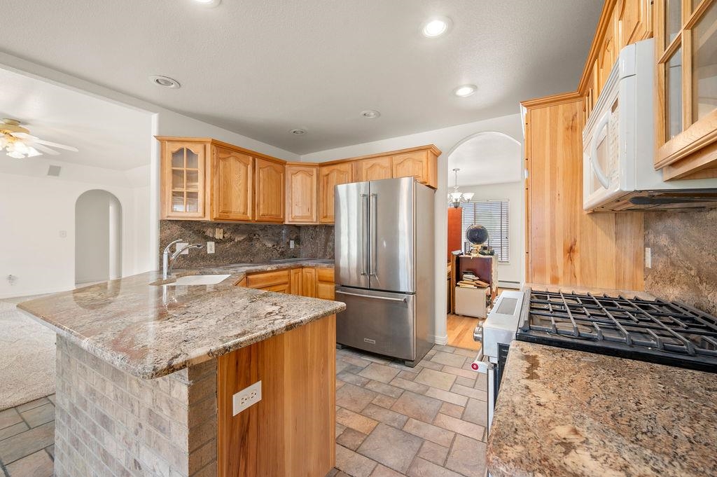 2285 Vista Rio Court Grand Junction, CO 81507 - Photo 25 of 34 a kitchen with stainless steel appliances granite countertop a sink stove and refrigerator