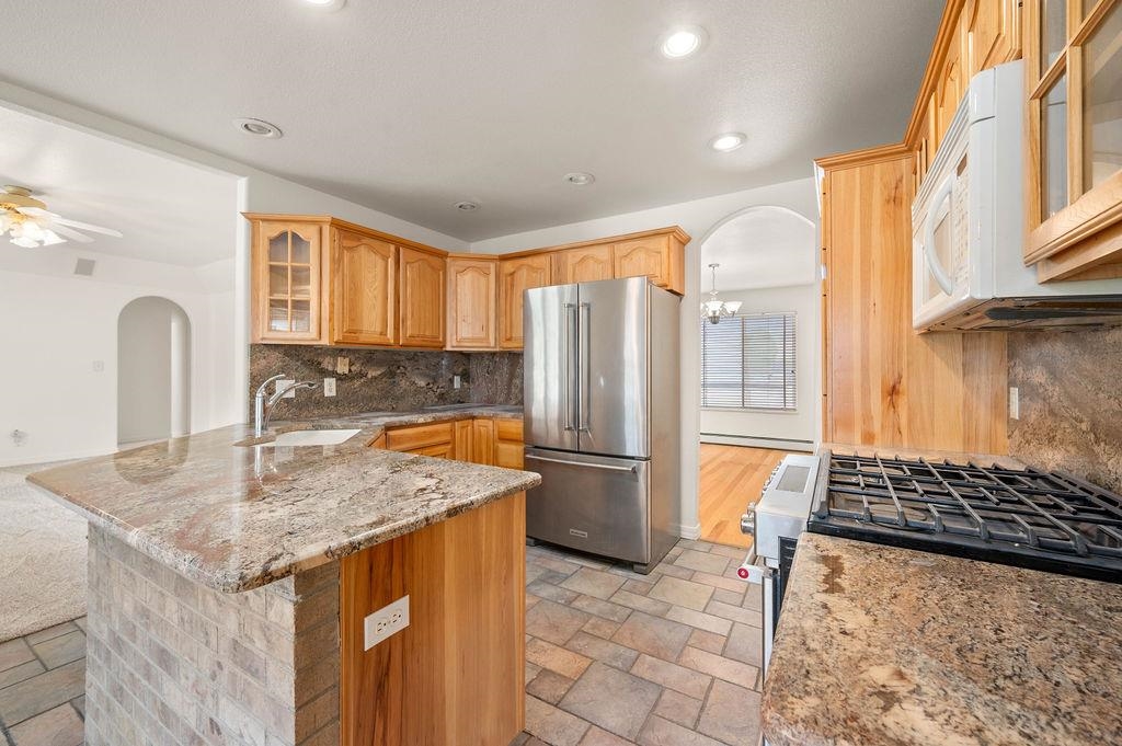 2285 Vista Rio Court Grand Junction, CO 81507 - Photo 26 of 34 a kitchen with stainless steel appliances granite countertop a sink stove and refrigerator
