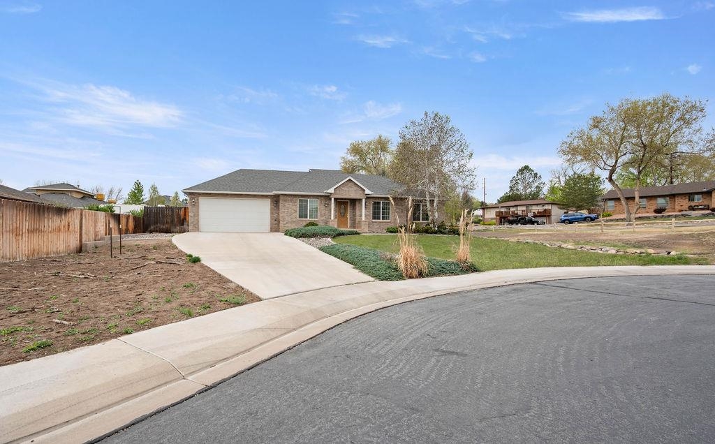 2285 Vista Rio Court Grand Junction, CO 81507 - Photo 3 of 34 a front view of a house with a yard and garage