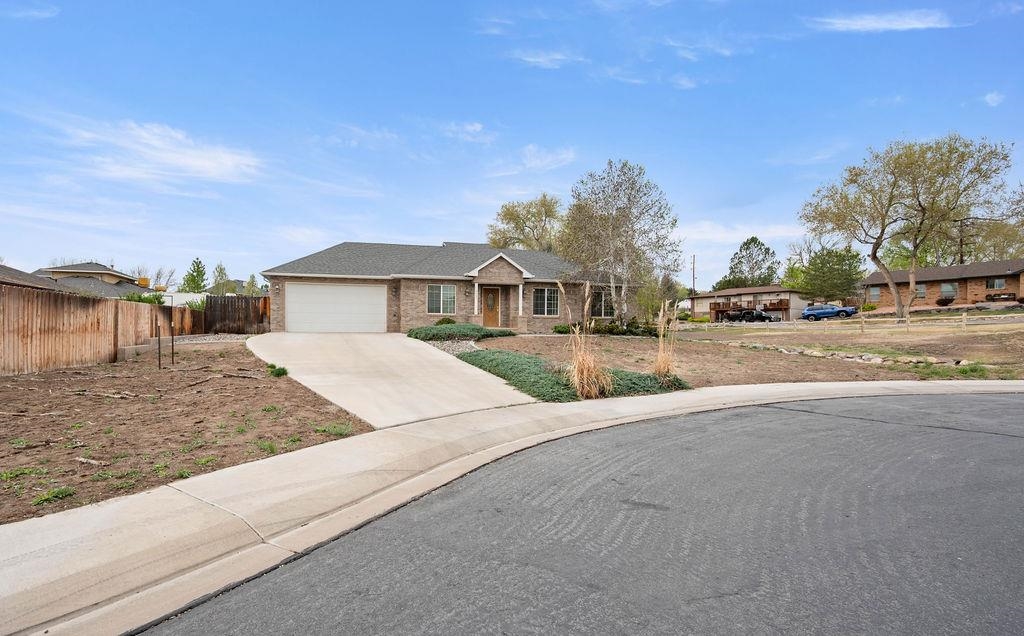 2285 Vista Rio Court Grand Junction, CO 81507 - Photo 4 of 34 a front view of a house with a yard and garage