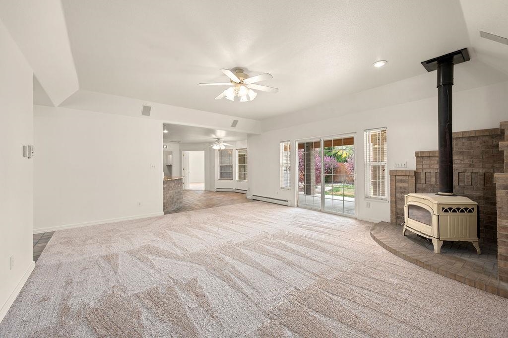 2285 Vista Rio Court Grand Junction, CO 81507 - Photo 8 of 34 a spacious bedroom with a large bed and a chandelier