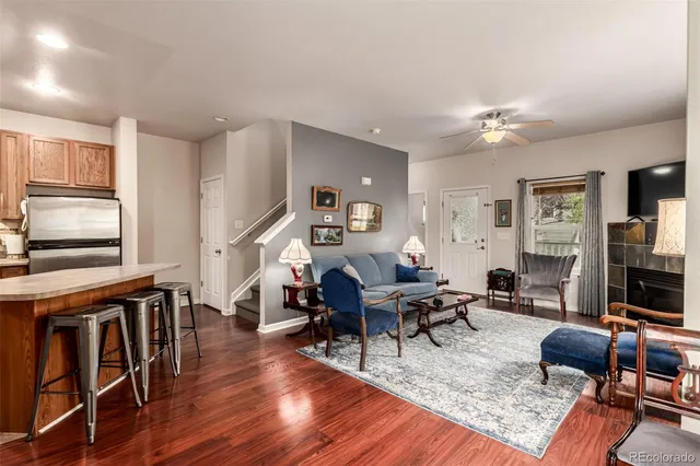 a living room with furniture dining table and wooden floor