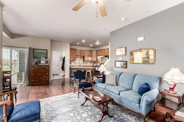 a living room with furniture kitchen view and a couch