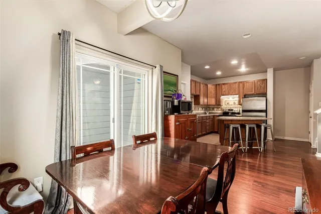 a kitchen with a table chairs stove and kitchen view