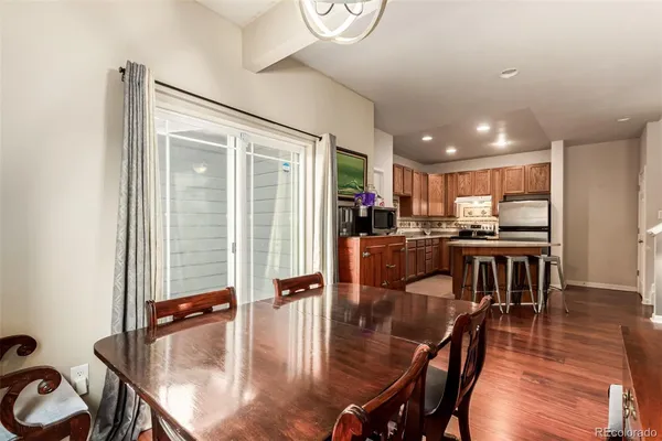 a kitchen with a table chairs stove and kitchen view