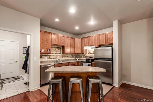 a kitchen with refrigerator a stove a sink and a microwave