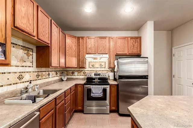 a kitchen with a sink stove and refrigerator