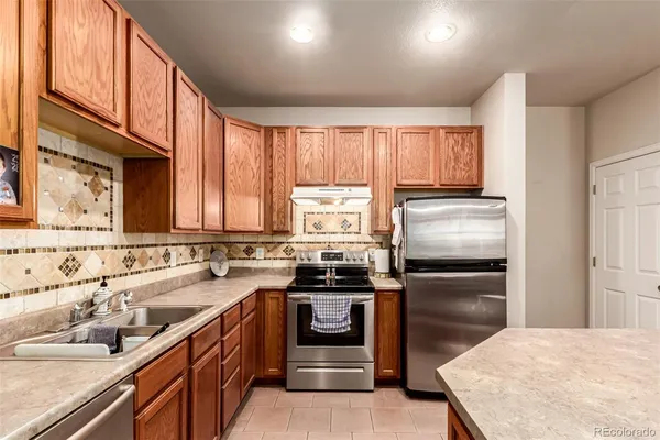 a kitchen with a sink stove and refrigerator