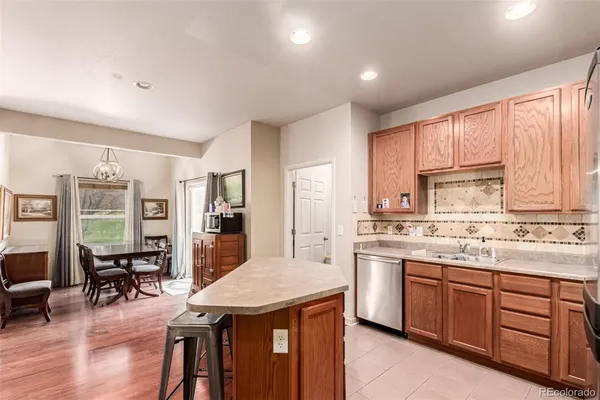 a kitchen with a stove a sink a dining table and chairs