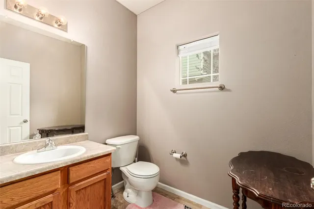 a bathroom with a toilet a sink and a mirror